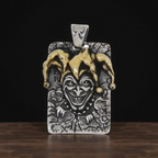 Joker-themed pendant with gold and silver accents on a dark background