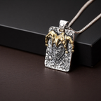 Pendant with detailed design on a dark surface