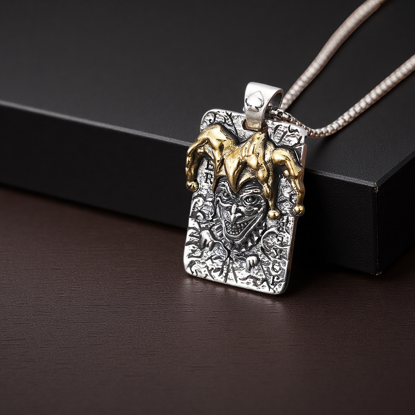 Pendant with detailed design on a dark surface