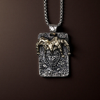 Silver pendant with a face design on a brown background