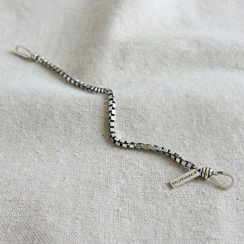 Silver bracelet on a light fabric background