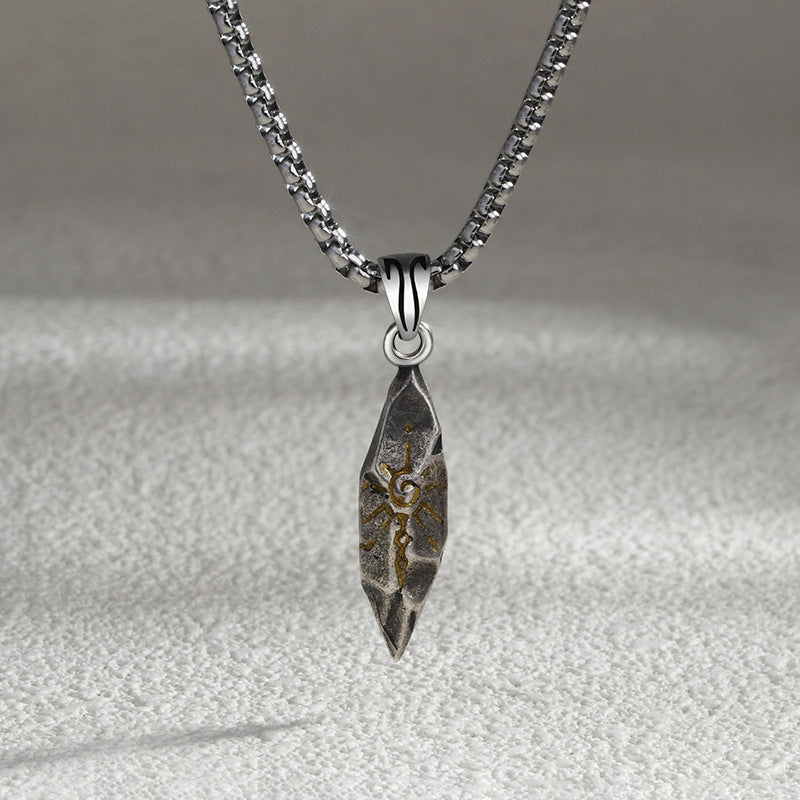 Silver pendant necklace on a textured gray background
