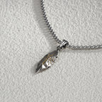 Silver necklace with a pendant on a light gray background