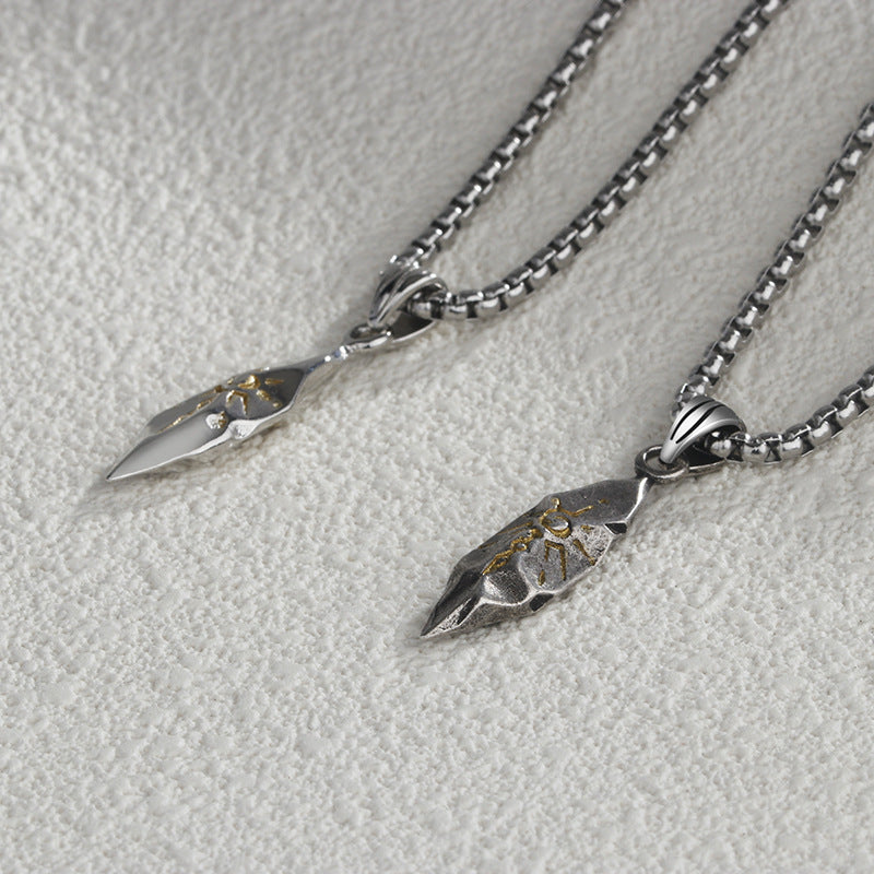 Two silver arrowhead pendants on chains against a light gray background