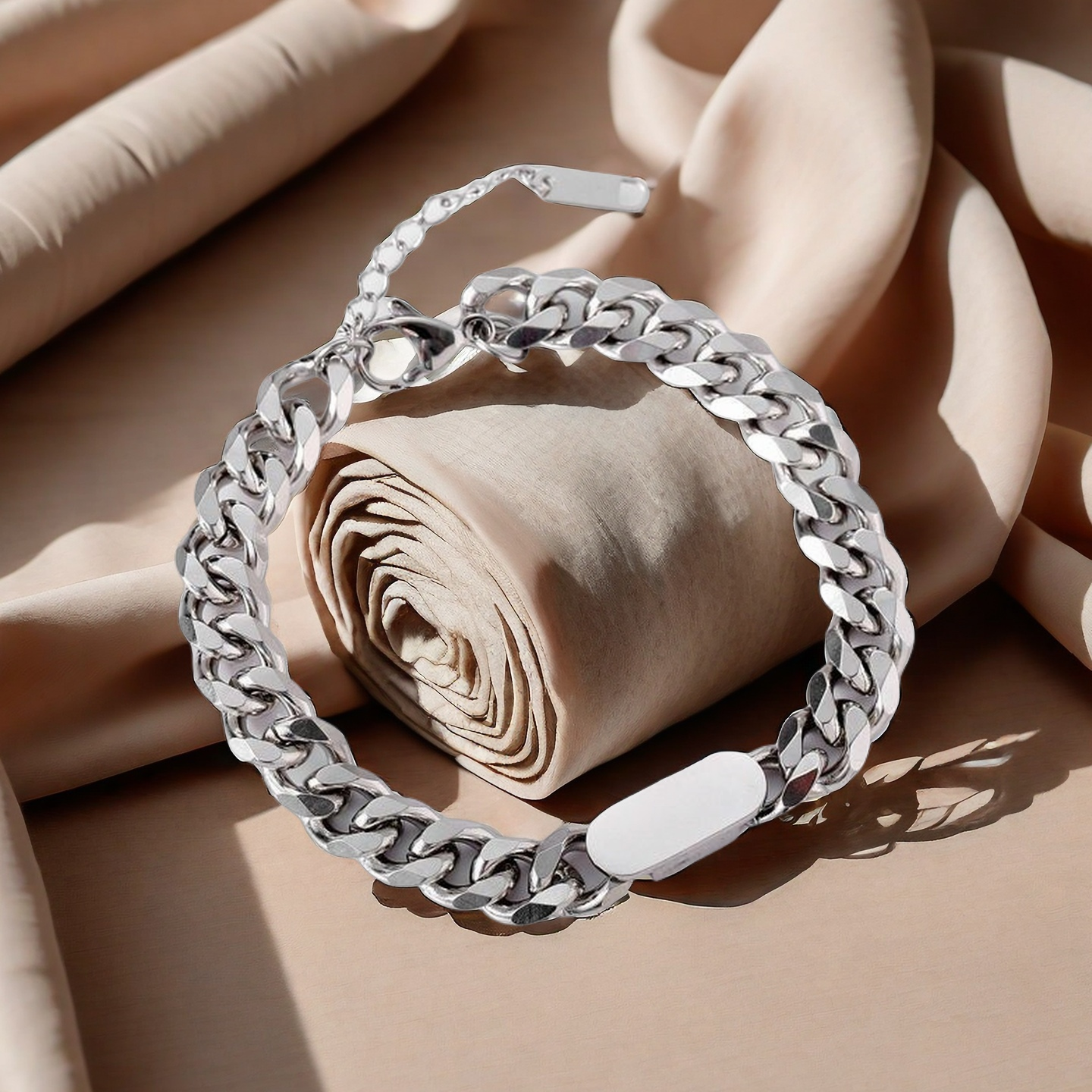 Silver chain bracelet on a beige fabric background