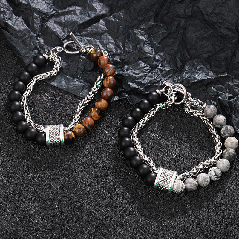 Two beaded bracelets on a textured black surface