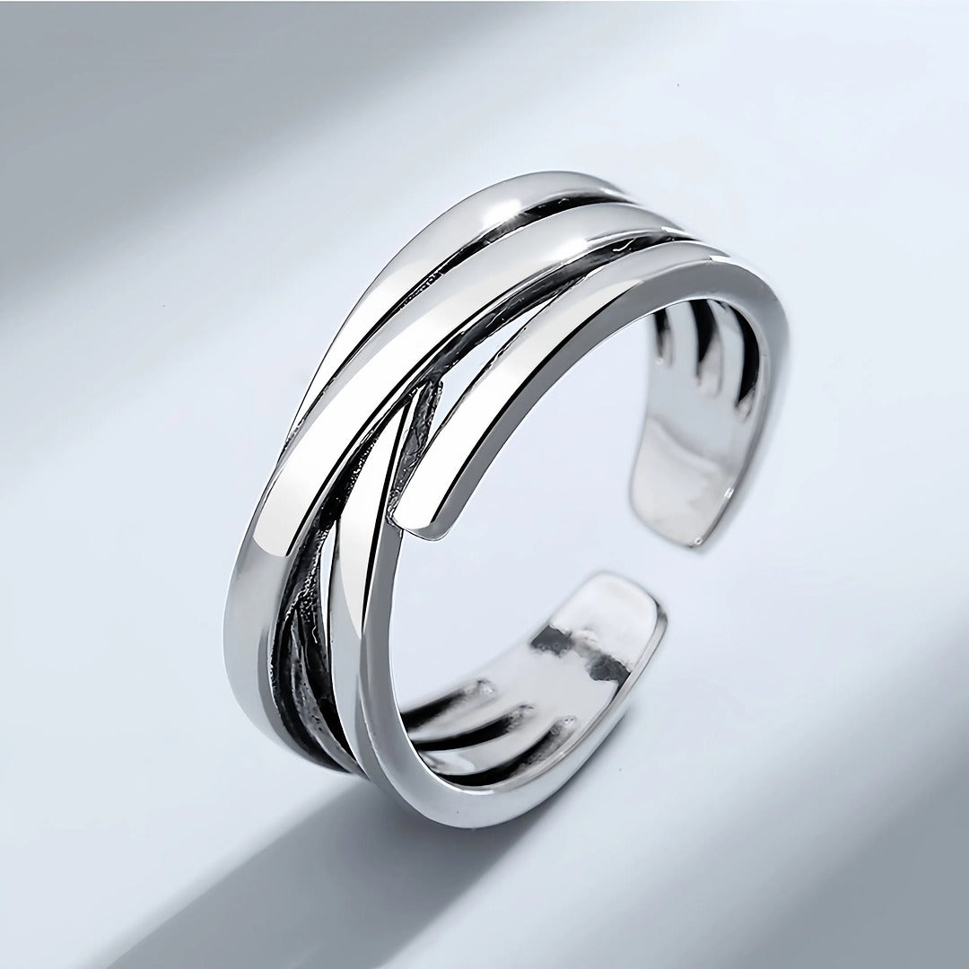 Silver ring with a modern design on a light gray background