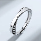 Silver ring with textured design on a light gray background