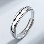Silver ring with a unique design on a light gray background