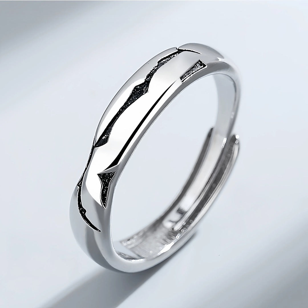 Silver ring with a unique design on a light gray background