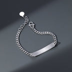 Silver chain bracelet with a bar clasp on a dark gray background
