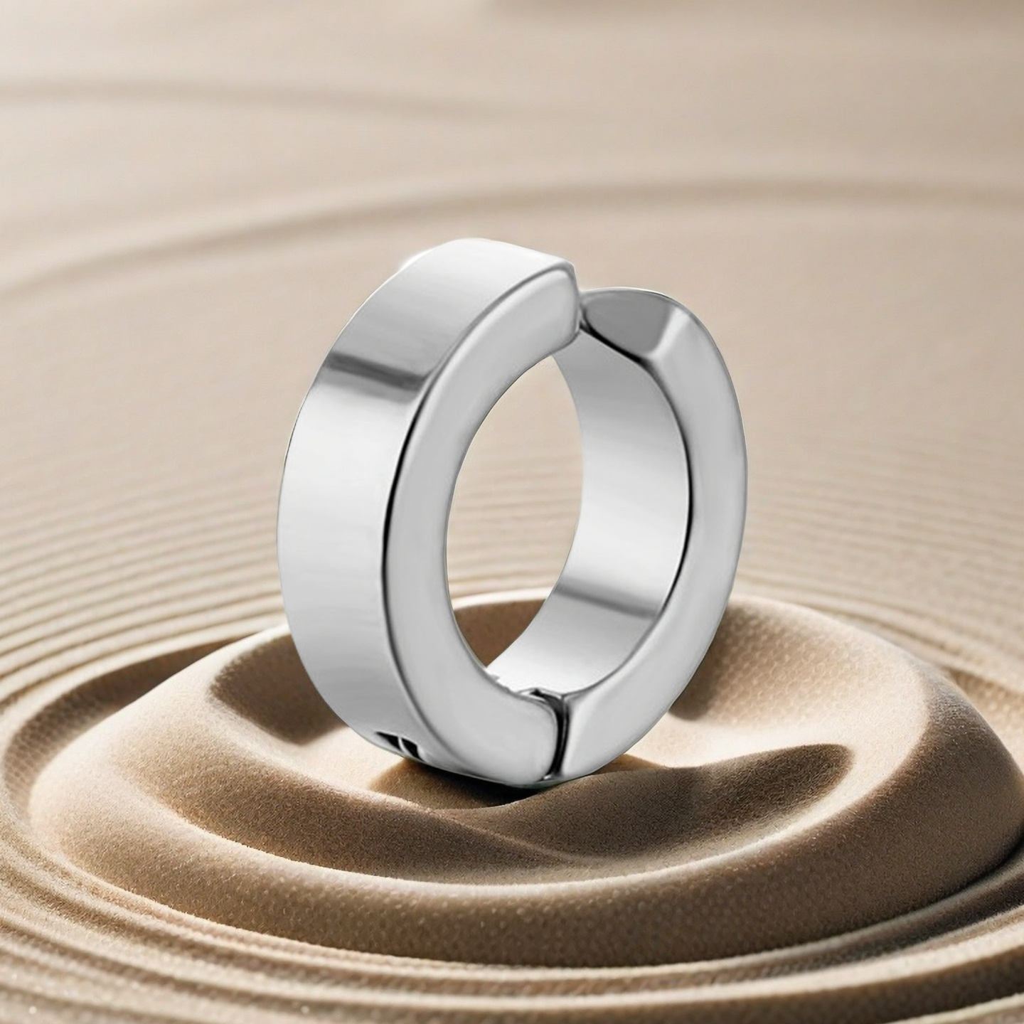 Silver ring on a textured beige surface