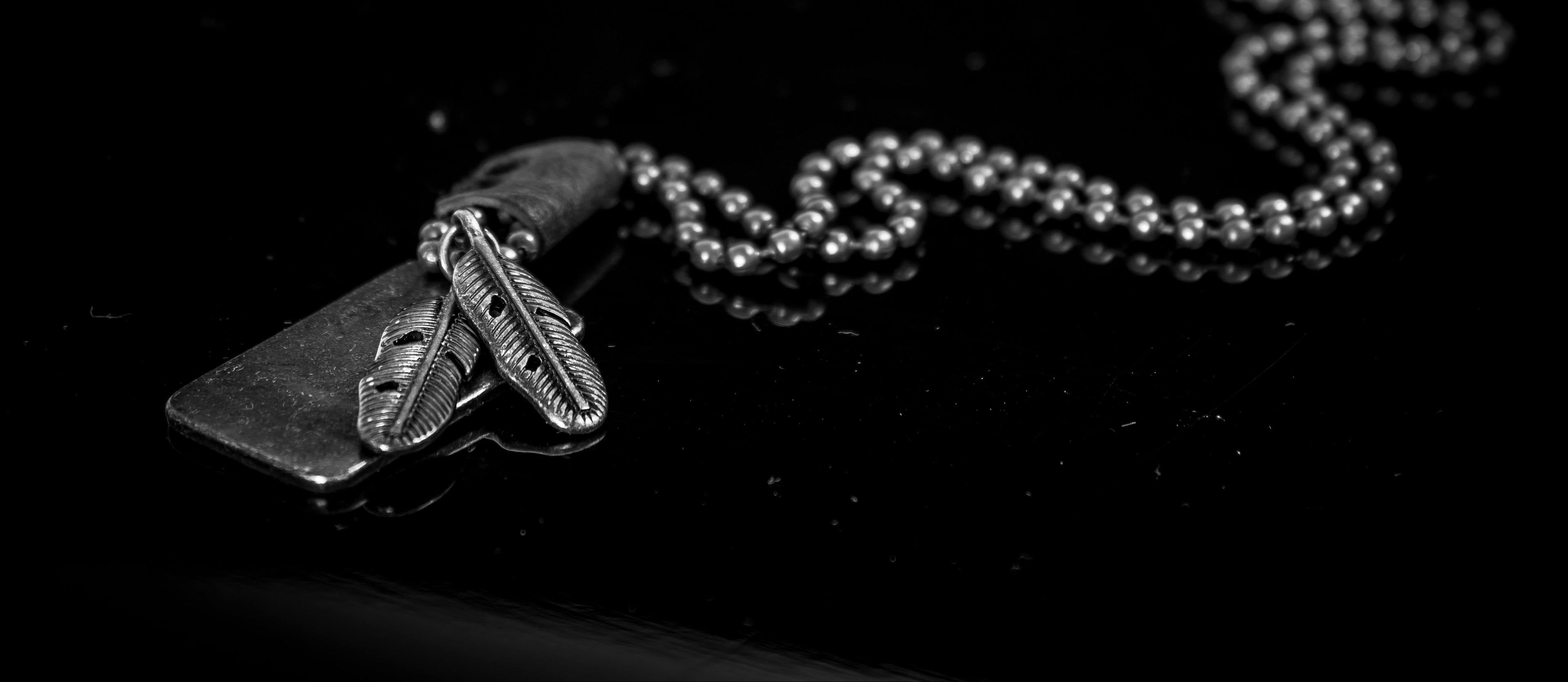 Close-up of a necklace with a pendant on a dark background